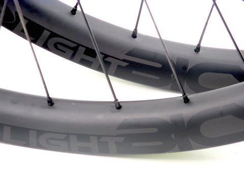 Picture of custom carbon wide enduro wheelset using Hope Pro4 on Light Bicycle MTB rims. Rim decals shown.