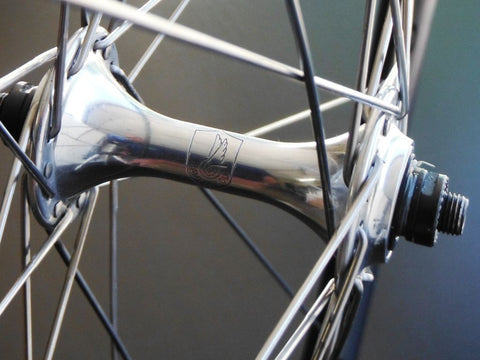 Image of custom retro bicycle wheels being Hplusson Archetype Grey Ano on Campagnolo Chorus hubs using Sapim Race spokes. Front hub shown.