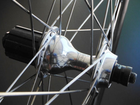 Image of custom retro bicycle wheels being Hplusson Archetype Grey Ano on Campagnolo Chorus hubs using Sapim Race spokes.