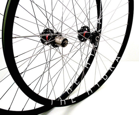 Image of custom handmade gravel road cyclocross disc wheelset by XLR8 wheels using Hplusson Hydra tubeless rims on Novatec 771 and 772 hubs.