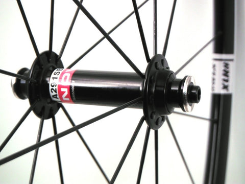 Image of XLR8 wheels custom alloy cyclocross road gravel wheelset using Kinlin XC279 rims and Novatec hubs. Front hub shown.