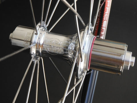 Image of custom XLR8 wheels Pacenti SL23 road bike alloy wheels on White industries T11 silver hubs. Rear hub shown.