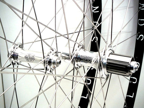 Photo of handmade bicycle wheels - Hplusson Archetype in black and polished White industries T11 hubs.