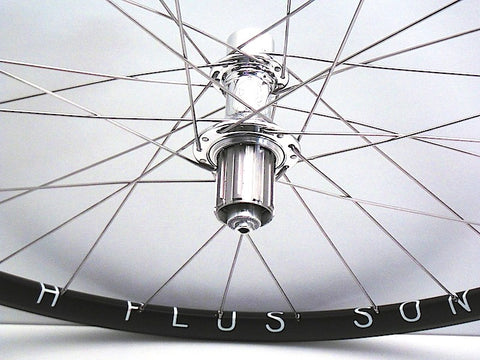 Pic of handmade bicycle wheels - Hplusson Archetype in black and polished White industries T11 hubs.
