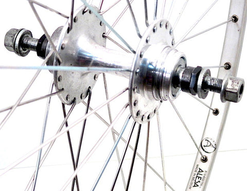 Image of retro track fixie wheel restoration by XLR8 wheels using Suzue hubs and Alesa silver rims.