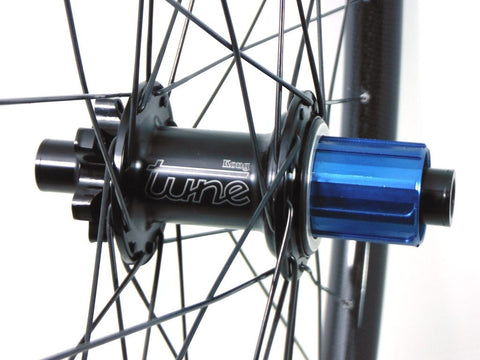 Photo of Light Bicycle Carbon MTB rims built onto Hope Evo and Tune Kong hubs by XLR8 wheels. Shows rear hub.