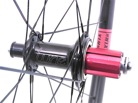 Image of custom carbon road time trail or triathlon bicycle wheels, built by XLR8. Tube Mig45 and Mag180 hubs are used with XLR8 Mistral C38 carbon tubeless clincher rims. Rear Campagnolo freehub pictured.