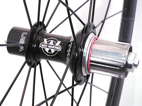 Photo of XLR8 Mistral T38 tubular carbon rims custom road bike racing wheels with White Industries T11 hubs in black. Image shows rear hub.