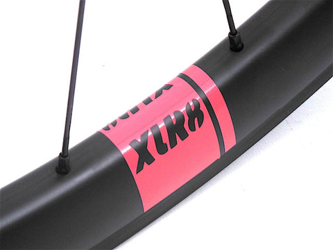 Image of custom carbon road time trail or triathlon bicycle wheels, built by XLR8. Tube Mig45 and Mag180 hubs are used with XLR8 Mistral C38 carbon tubeless clincher rims. XLR8 red decals shown.