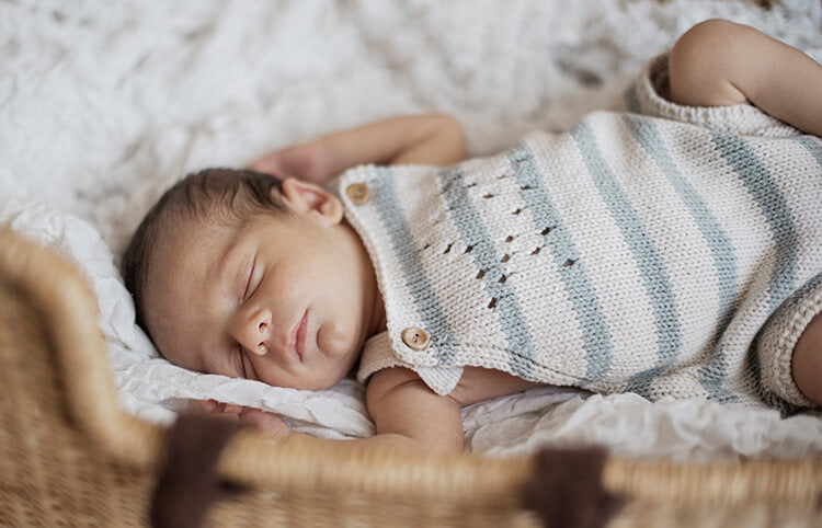 baby sleeping wearing cute romper