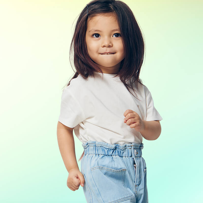toddler girl wearing white t-shirt and denim pants