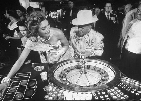 Vintage Las Vegas 1950s casino with couple in glamourous outfits playing roulette
