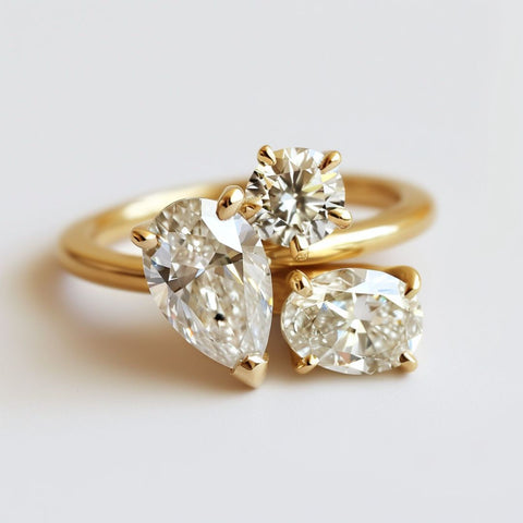 Alternative non-traditional Engagement Ring tot et moi modern cluster style with pear oval and round cut diamonds