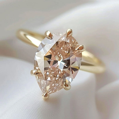 Non traditional diamond solitaire engagement ring pear cut peach fuzz or argyle pinky-champagne pear cut diamond