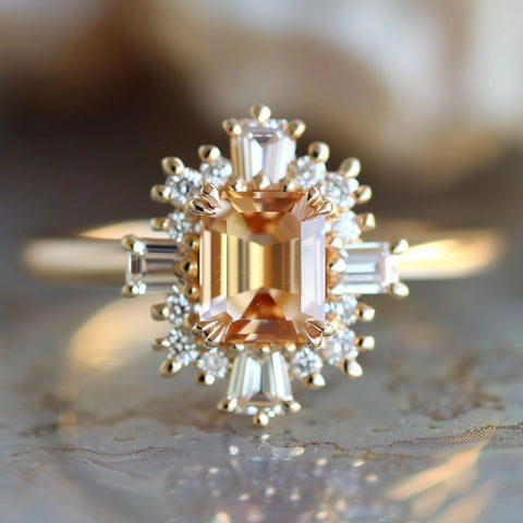 fairycore fantasy engagement ring with and emerald cut peach colored sapphire diamond baguette halo
