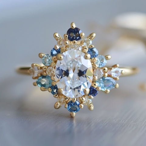 fairycore fantasy engagement ring with oval cut diamond and blue sapphire halo