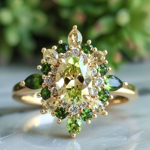 Fairycore fantasy engagement ring with oval cut light green sapphire and pear cut green emerald and tourmaline halo