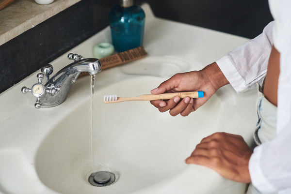 Brushing with a BAMWOO bamboo toothbrush