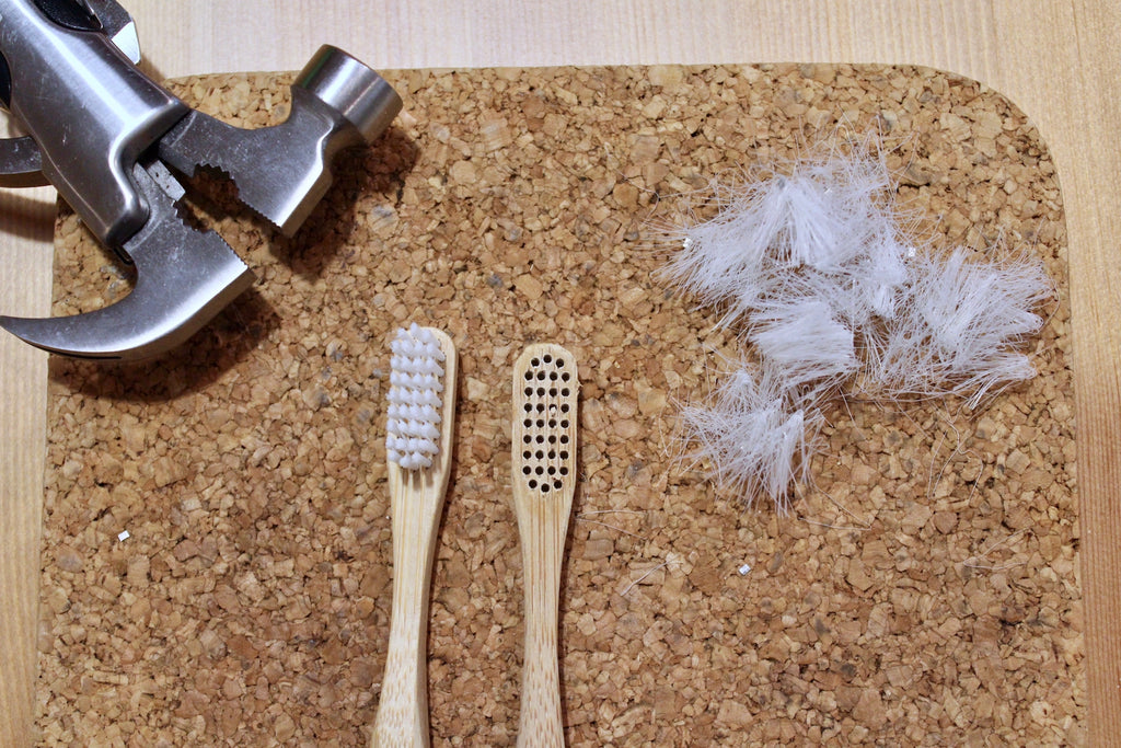 Old bamboo toothbrush with bristles removed ready to be disposed of properly