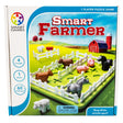 Smart Farmer game box. The cover shows the actual game in play. The green rectangle-shaped game board has white fence pieces all around the edge and a few through the middle. You can see cows, pigs, and horses inside the fence. Off to the side are 2 sheep, more fence pieces and a water dish. In the background are rolling green hills and a red barn. The box indicated that it is a 1 player game, the age recommendation is for 4 and older, and there are 60 challenges.