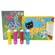 The Djeco Spot the Dot kit box with a project standing up in front of 4 dot markers. The project on the left is of a turtle and butterfly. The smiling turtle is on grass, surrounded by flowers, butterflies, and other woodland bugs. The set box on the right shows a cat standing on grass, also surrounded by flowers and bugs. The dot markers in the front-left are red, pink, yellow, and blue. 