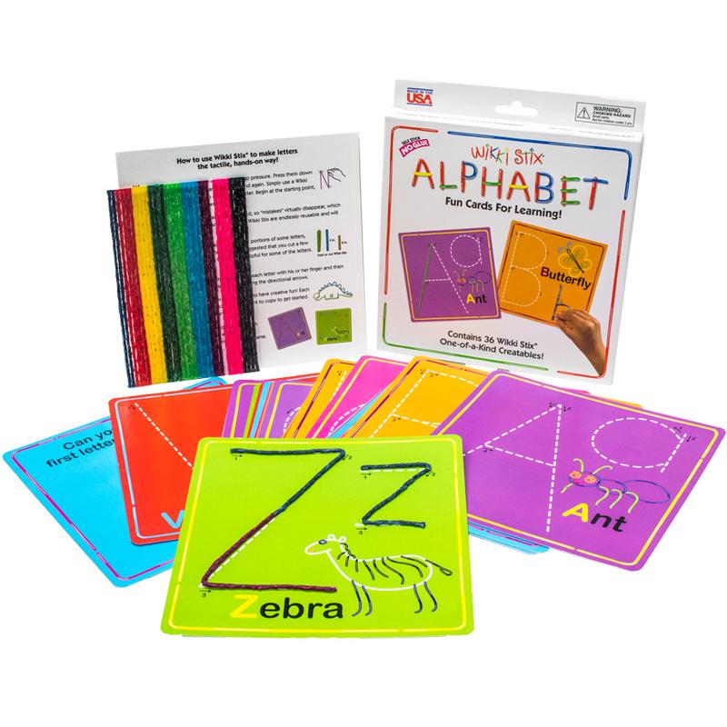 The Wikki Stix Alphabet Deluxe set. In the left-back are many wax sticks leaned up against an instruction board. To the right is the Alphabet set box that has a sample of the A and B boards on the cover. In front of the box are the alphabet boards all fanned out. In the front-middle is the Z card with an upper and lowercase z and a zebra image in the lower-right. You can see the A card to the right and the other cards are covered by each other.