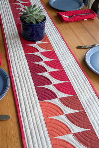 quilted table runner with Oakshott Fabrics Ruby Red bundle of shot cottons