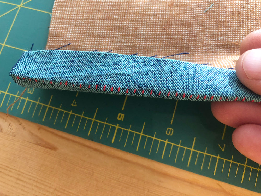 Bending the long side to get it to open correctly for the next row of stitches