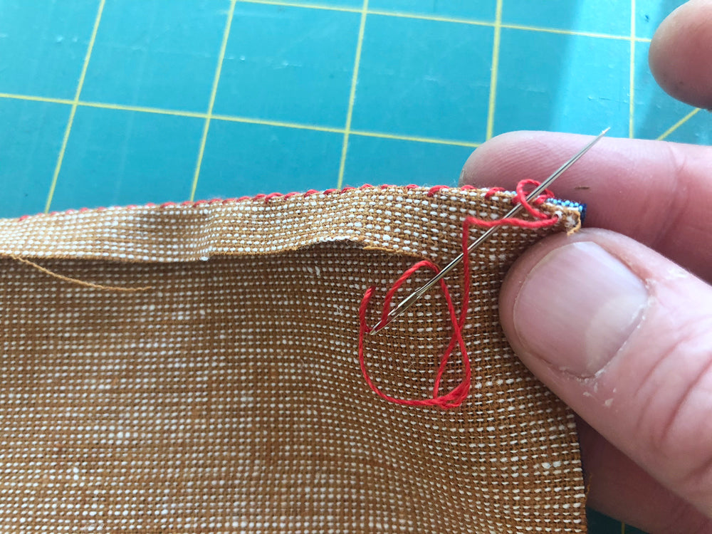 The knot at the end of the first round of stitches