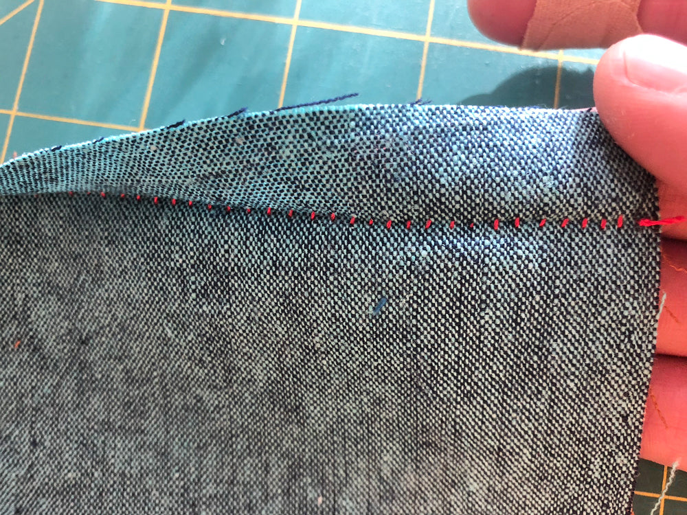 Opening up the long side after whipstitching the first round of stitches.