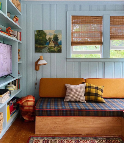 Cosy blue painted room with a check couch