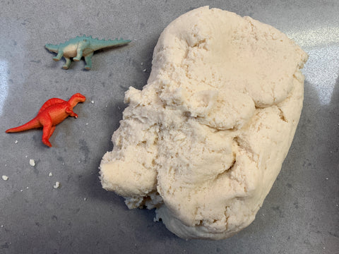 salt dough with two small dinosaur toys