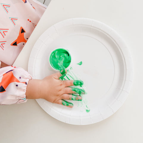 Child's hand with green fingerpaint