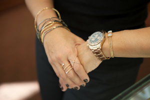 womans-hands-with-stacked-bracelets-watch-and-rings