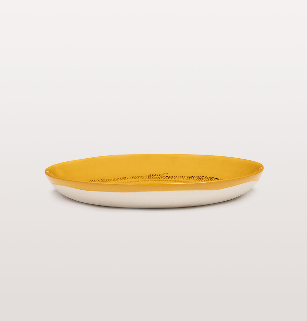 Extra small plates for bread or fruit by Ottolenghi. Multi-coloured mini plates by Ottolenghi x Serax. Yellow, blue, white, pink and green. UK stockist. W.A.GREEN | OTTOLENGHI X SERAX | Sunny Yellow and Swirl Dots Black extra small plate side view. £16 wagreen.co.uk