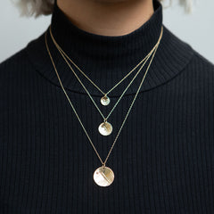 Model wearing 14K gold mountain necklaces
