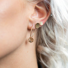 Model wearing 14K gold geometric stud earrings