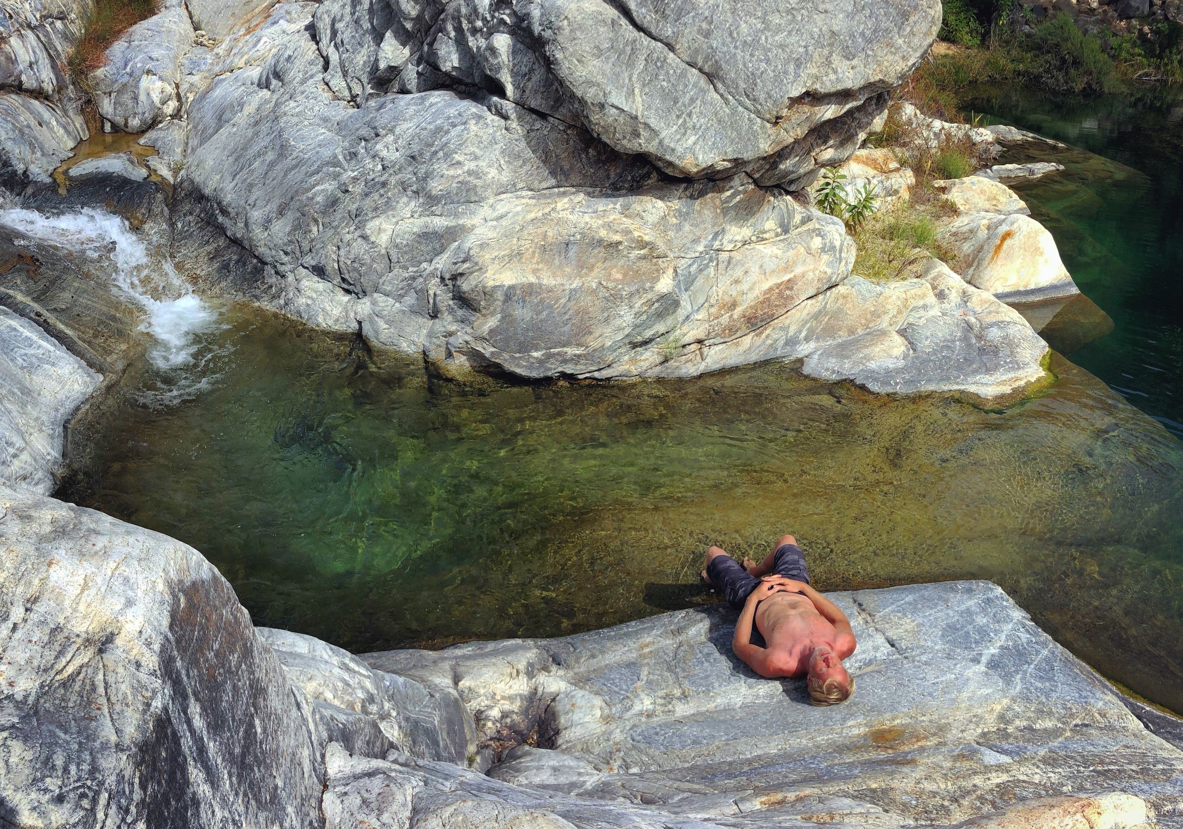 resting by a water source while camping in the desert