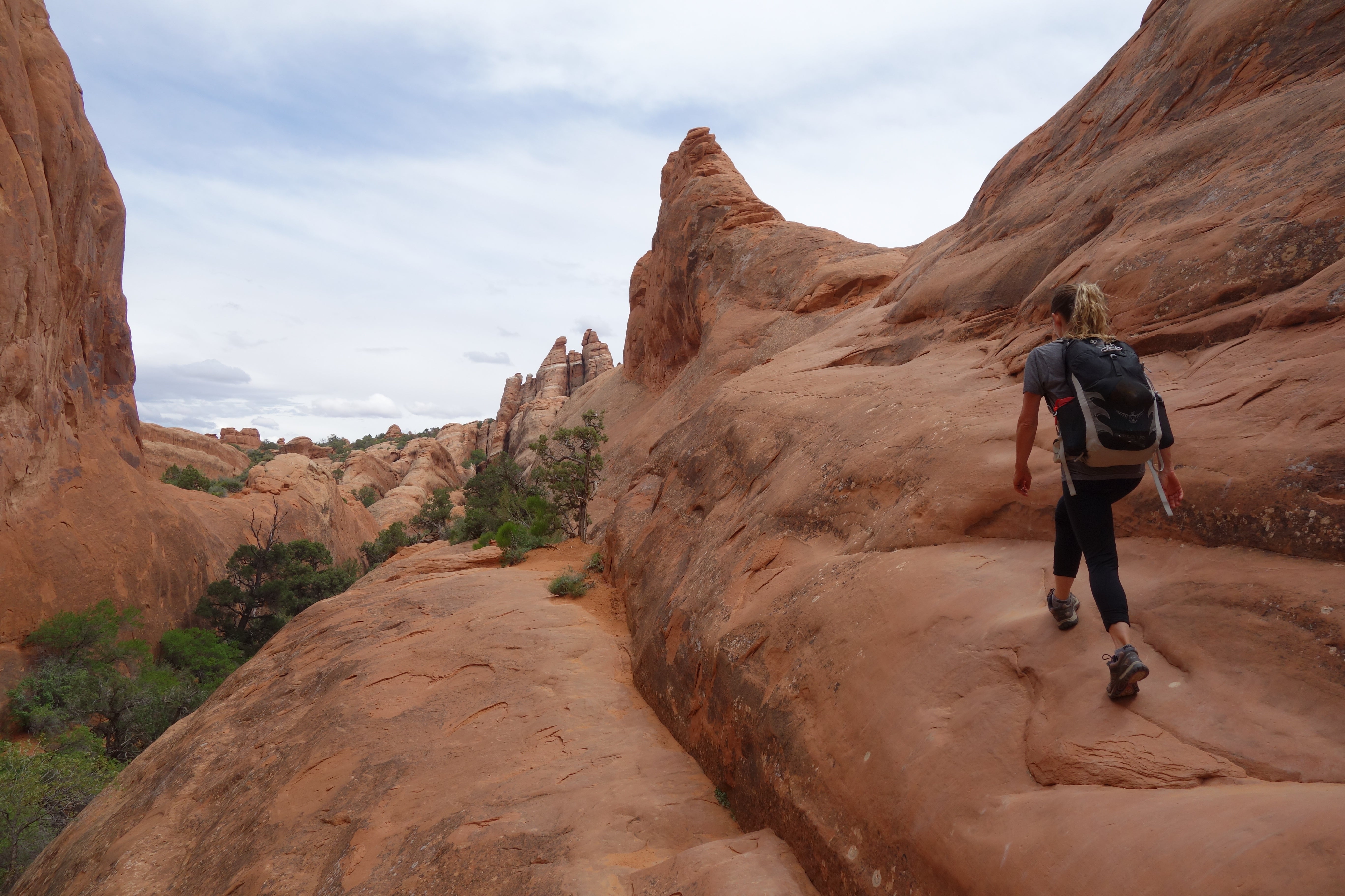 hiker practicing social distancing on a trail in Moab