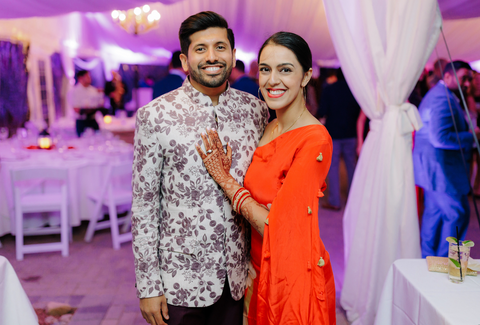 Rohini in the Red Feather Pop Cape dress