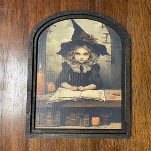 Witch behind desk at Academy w/ Candles in Small Arch Frame - Black River Antiques and Gifts, LLC