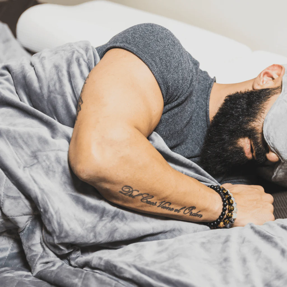 Man sleeping with a weighted blanket