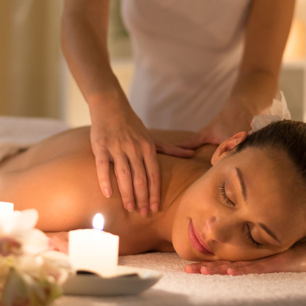 Person enjoying a massage, lying face down on a massage bed.