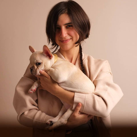 Kelsey McLeod Founder of déjà skincare holding french bulldog