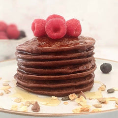 Chocolate keto pancakes with raspberries on top