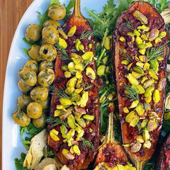Rose harissa roasted aubergine with pistachios artichokes and olives