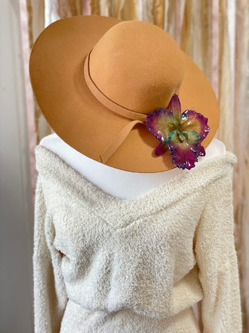 orchid hair piece on a hat