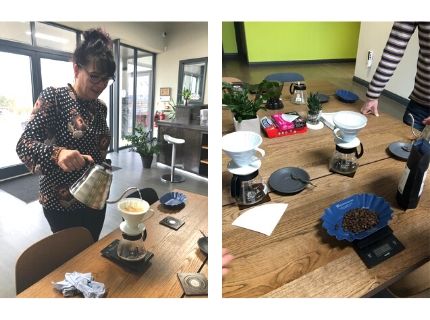 Woman taking part in a barista coffee experience with coffee making equipment on table