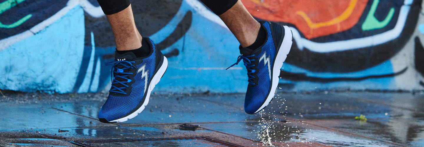 Close-up of man running in blue and black men's 361 running shoes in the city