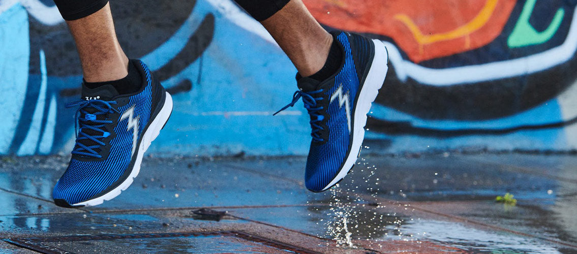 Close-up of man running in blue and black men's 361 running shoes in the city